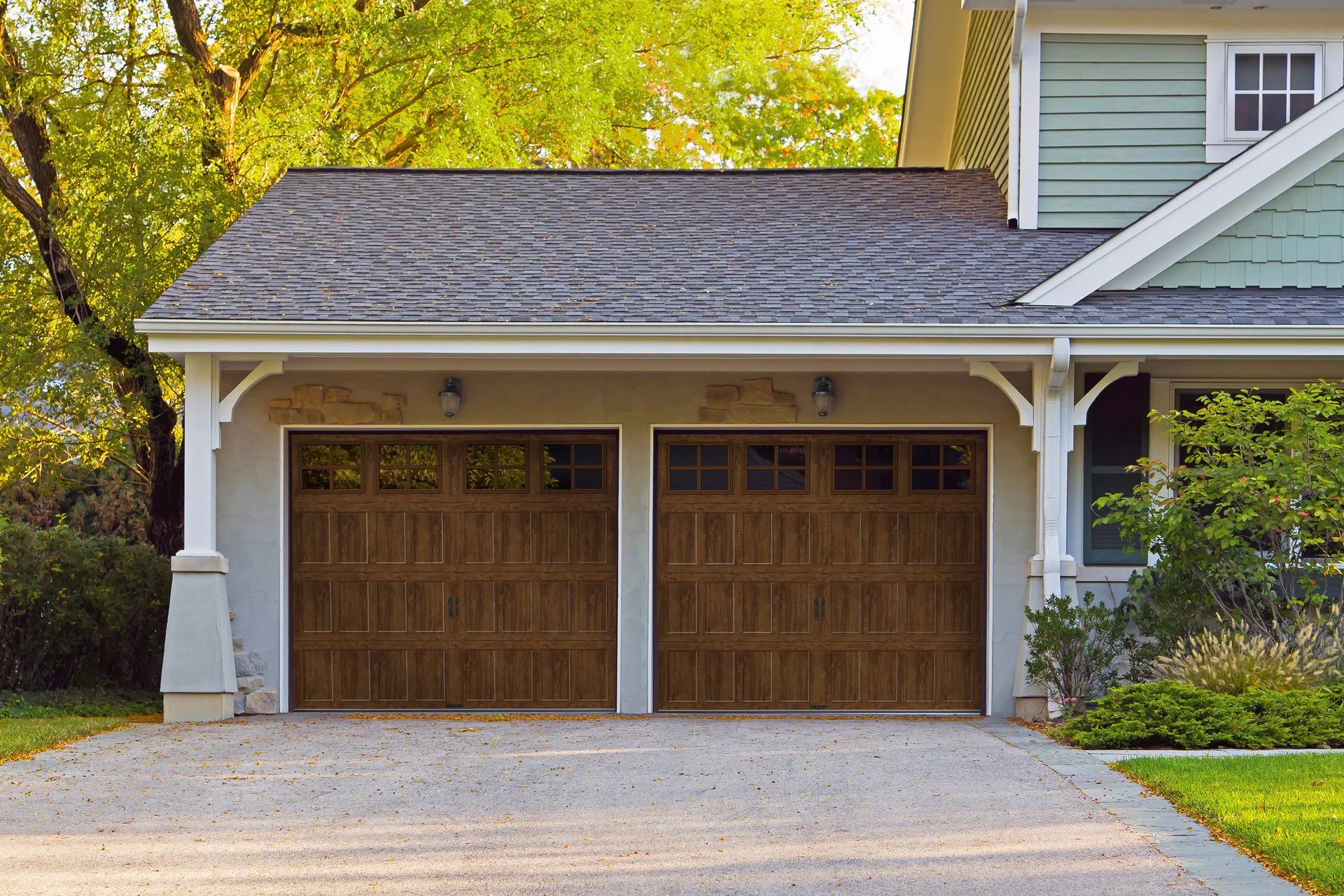 Craftsman home with two walnut carriage house garage doors