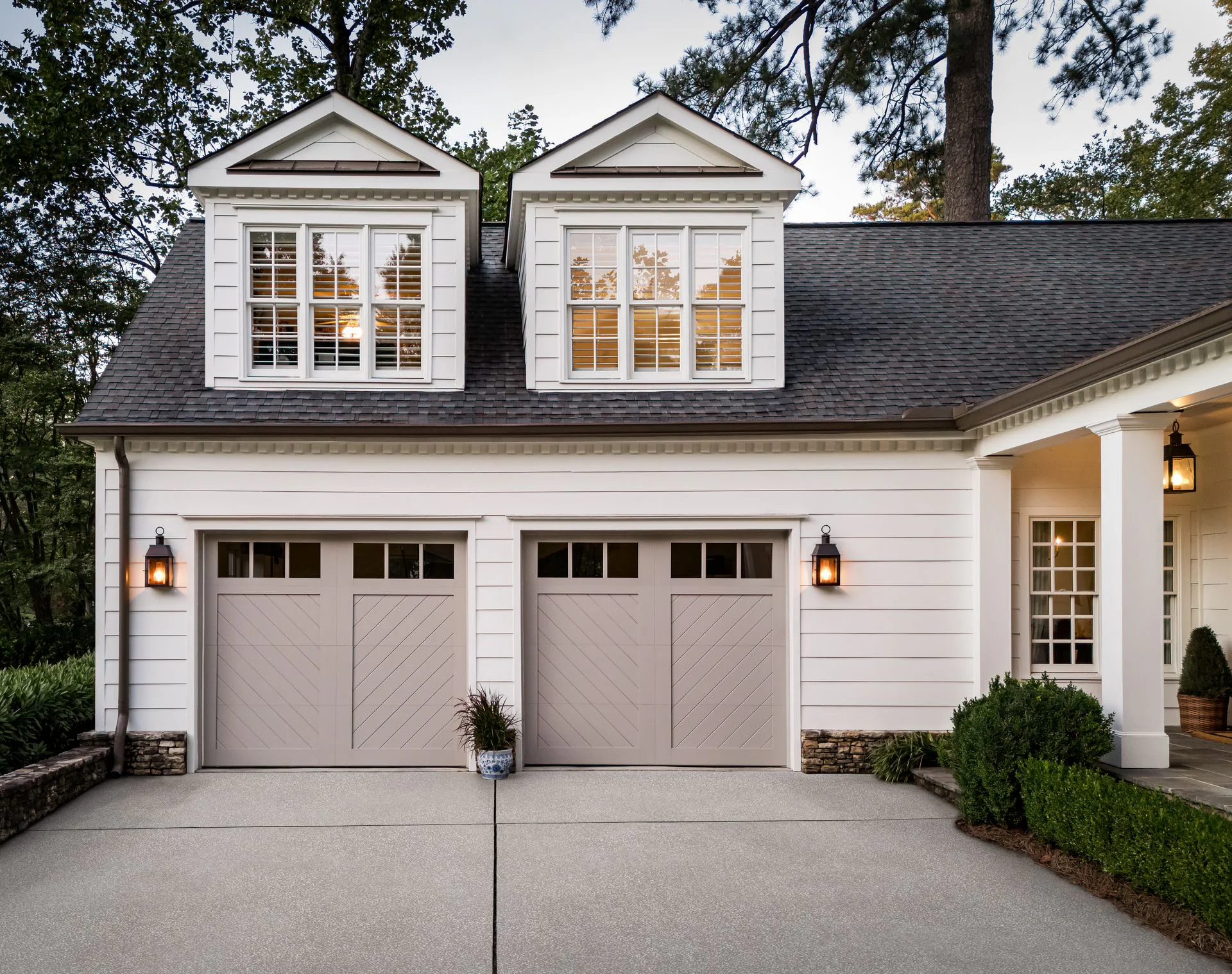 White home with two chevron-pattern carriage house garage doors