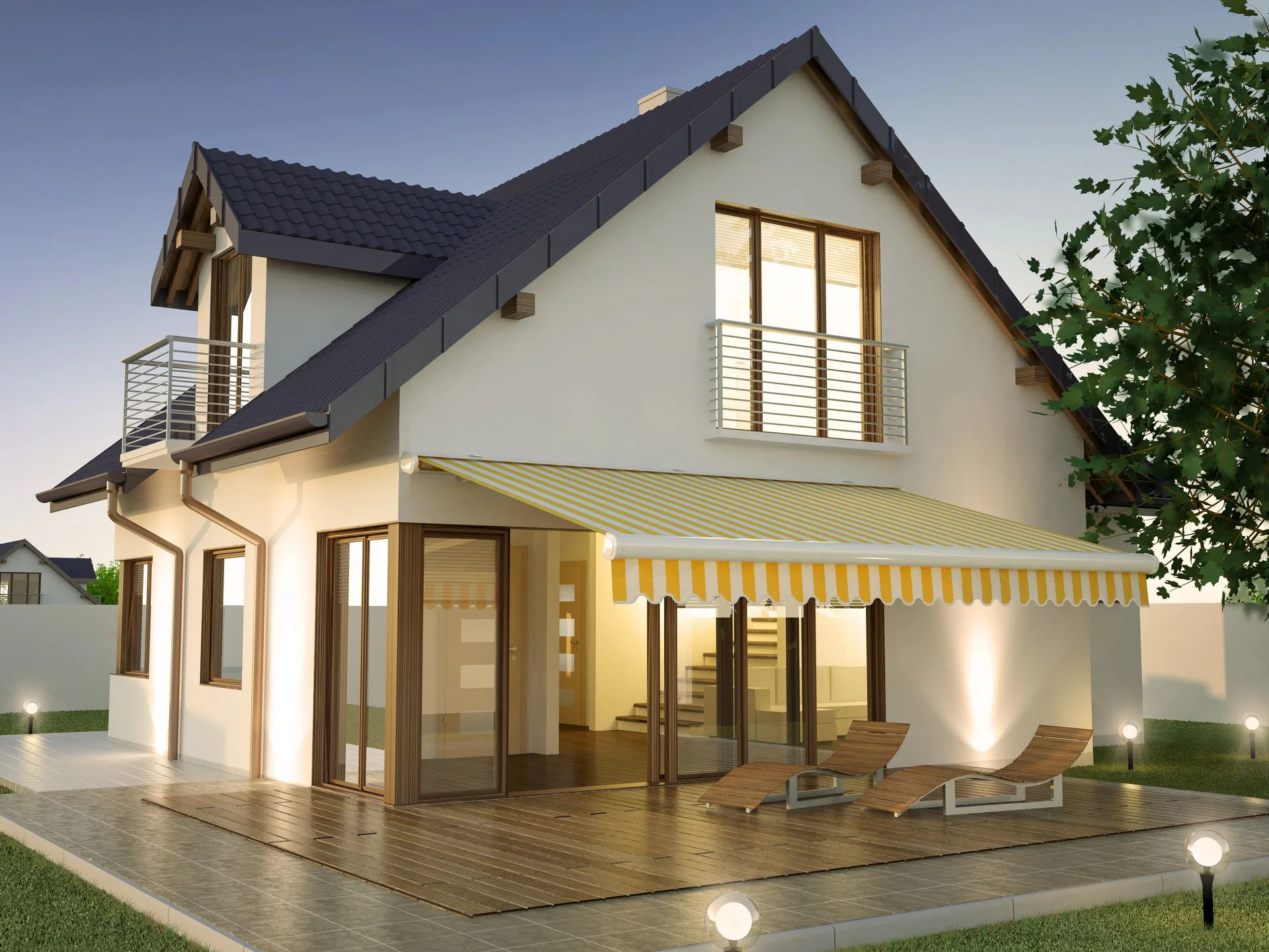 Home at dusk with a retractable patio awning over the deck